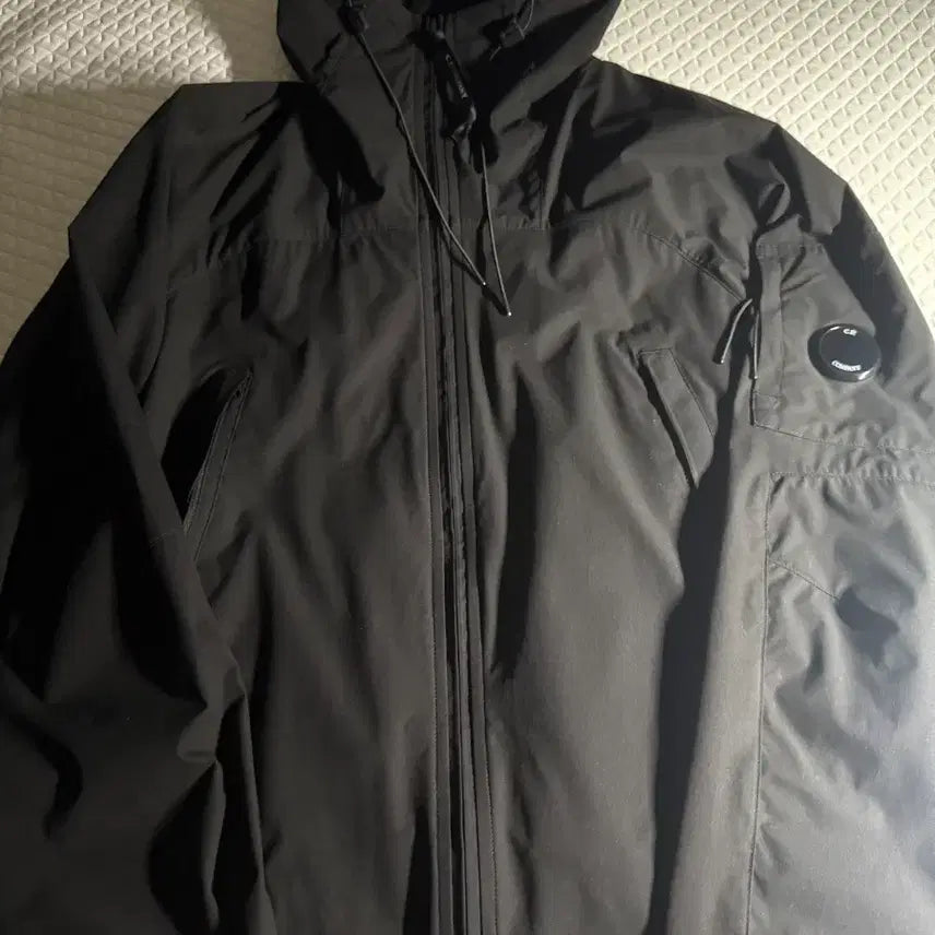 [BUNJANG] C.P. Company Protect Lens Hooded Jacket Black 26SS / C.P. 컴퍼니 프로텍 렌즈 후드 자켓 블랙 - 26SS