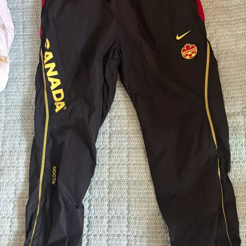 [BUNJANG] Nike x Drake NOCTA Woven Track Pants Black (IM3236-010) / 나이키 x 드레이크 녹타 캐나다 우븐 트랙 팬츠 블랙 (IM3236-010)