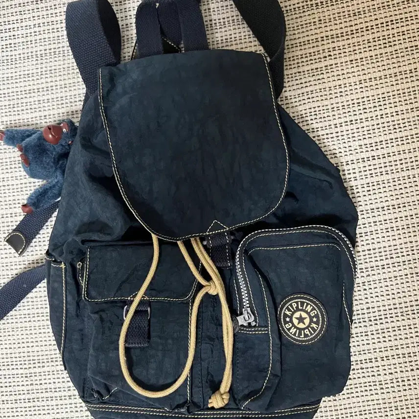 [BUNJANG] Kipling Stitch Two-Pocket Drawstring Backpack / 키플링 스티치 투포켓 복조리 백팩